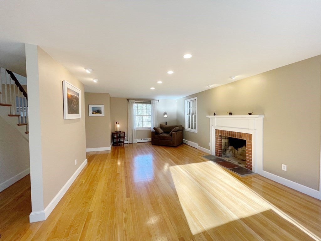 61 3 Ponds Road Wayland, MA 01778 - Photo 4 of 33 a living room with furniture and a fireplace