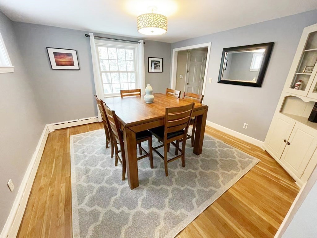 61 3 Ponds Road Wayland, MA 01778 - Photo 7 of 33 a view of a dining room with furniture and wooden floor