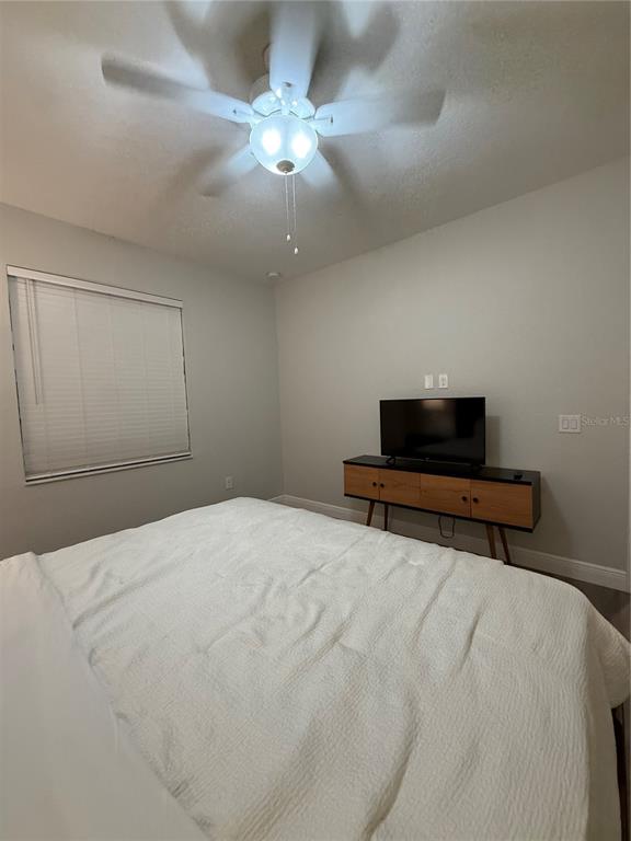 26267 Explorer Road Punta Gorda, FL 33983 - Photo 12 of 27 a bedroom with a bed and a ceiling fan
