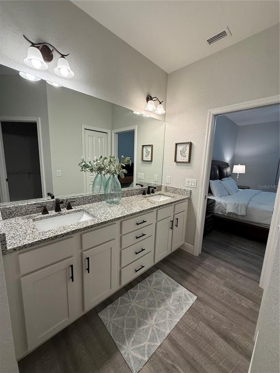 26267 Explorer Road Punta Gorda, FL 33983 - Photo 13 of 27 a spacious bathroom with a double vanity sink and a mirror