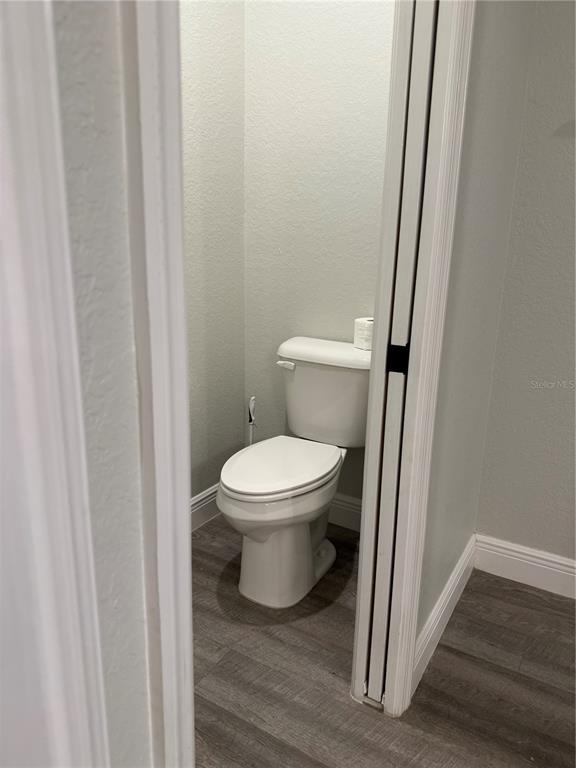26267 Explorer Road Punta Gorda, FL 33983 - Photo 20 of 27 a white toilet sitting next to a wooden cabinet