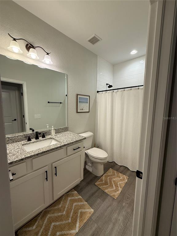 26267 Explorer Road Punta Gorda, FL 33983 - Photo 3 of 27 a bathroom with a double vanity sink toilet and mirror
