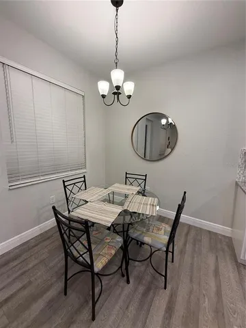 a view of a dining room with furniture wooden floor and chandelier