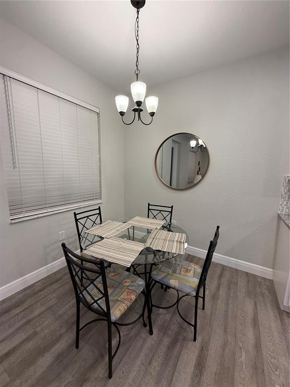 26267 Explorer Road Punta Gorda, FL 33983 - Photo 7 of 27 a view of a dining room with furniture wooden floor and chandelier