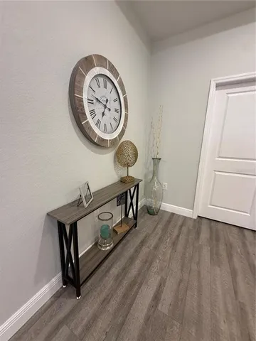 a view of a room with a wooden floor and a table