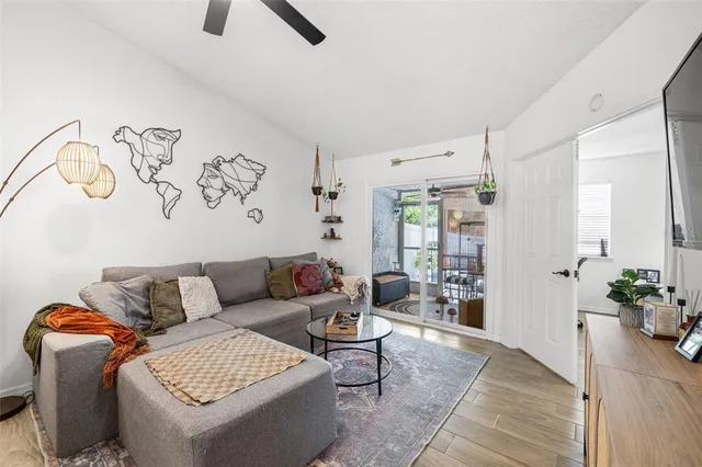 a living room with furniture and wooden floor