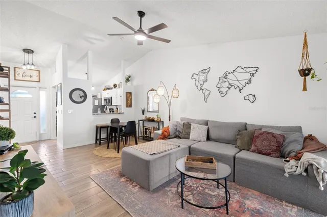 a living room with furniture and a chandelier