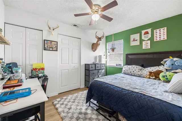 a bedroom with a bed dresser and a window