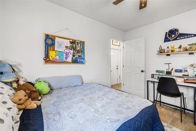 a bedroom with a bed and a painting on the wall