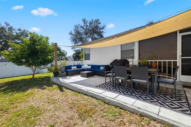 a view of a backyard with furniture porch and a patio