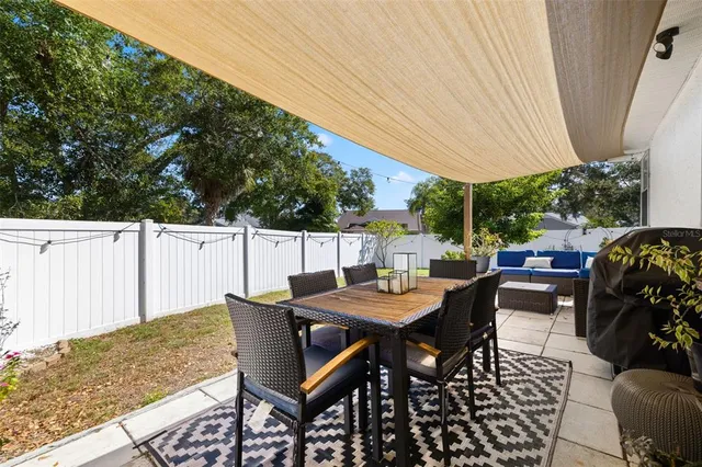 a view of a backyard with table and chairs