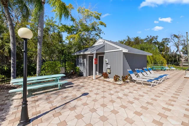 a view of a house with backyard and sitting area