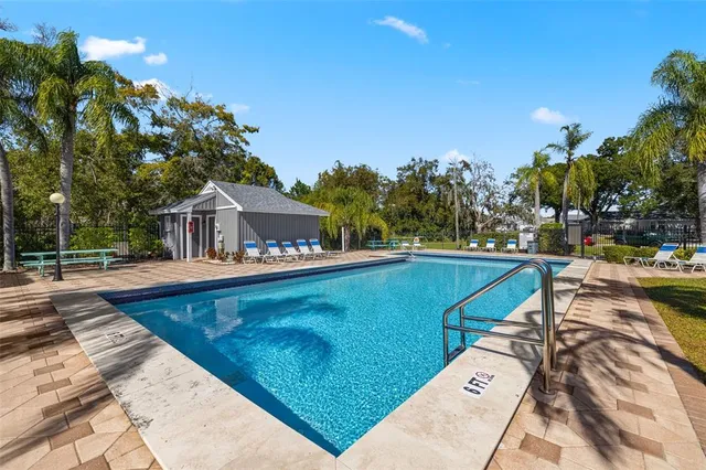 a view of swimming pool with outdoor seating and deck