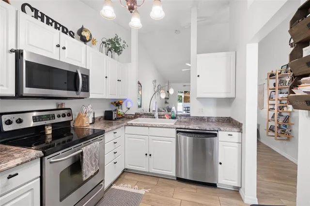 a kitchen with stainless steel appliances a stove microwave and cabinets