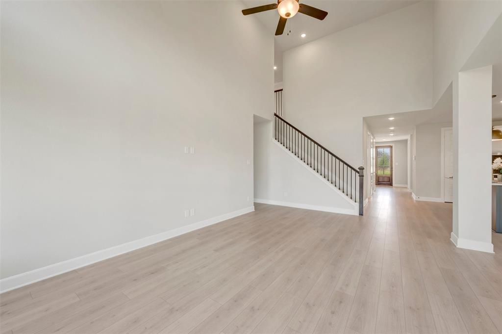 4308 Palomino Road Aubrey, TX 76227 - Photo 23 of 40 a view of an empty room with wooden floor