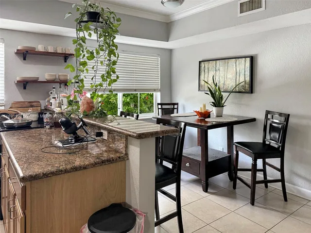 a view of a dining room with furniture and a potted plant