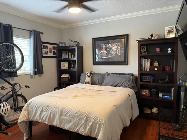 a bed sitting in a bedroom next to a bookshelf