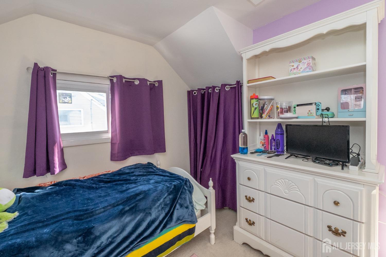 258 Sunset Avenue Old Bridge, NJ 08857 - Photo 13 of 27 a bedroom with a bed and a flat screen tv