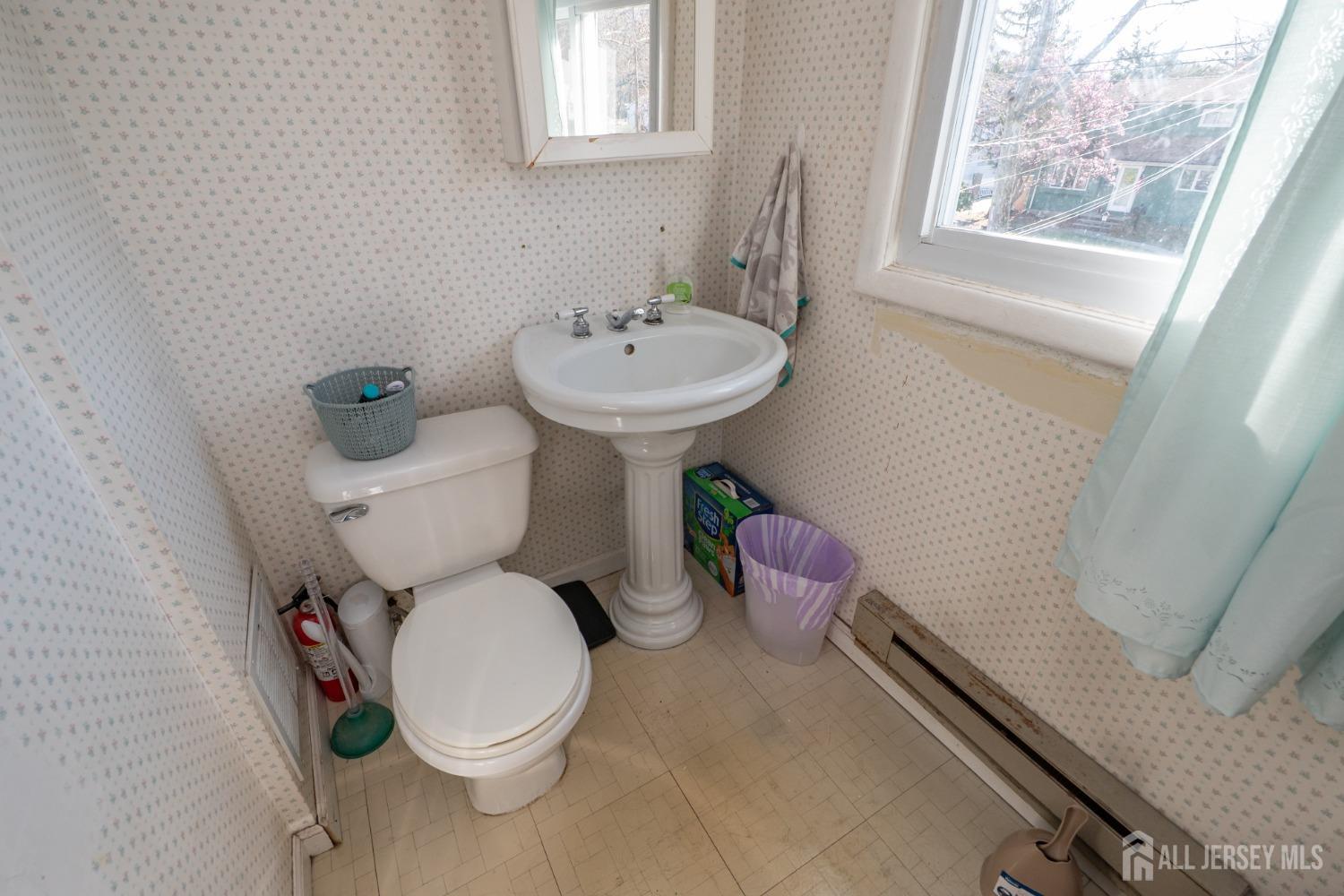258 Sunset Avenue Old Bridge, NJ 08857 - Photo 15 of 27 a white toilet sitting next to a bathroom sink