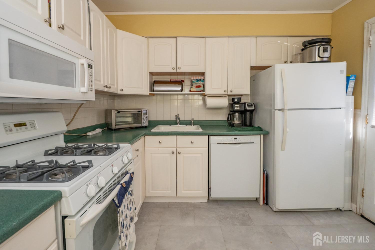 258 Sunset Avenue Old Bridge, NJ 08857 - Photo 22 of 27 a kitchen with appliances a sink and cabinets