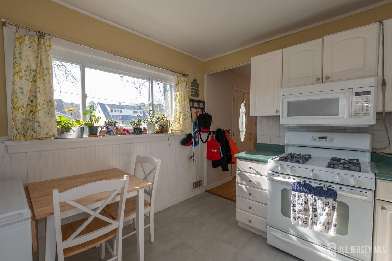 258 Sunset Avenue Old Bridge, NJ 08857 - Photo 23 of 27 a kitchen with a stove a refrigerator and a window
