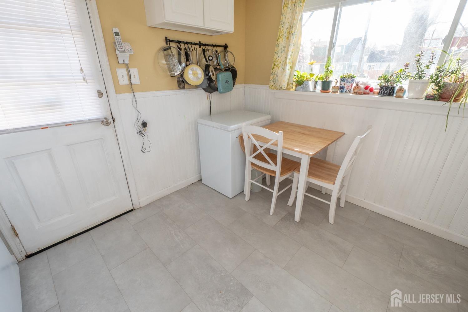 258 Sunset Avenue Old Bridge, NJ 08857 - Photo 24 of 27 a view of a dining room with furniture and a floor to ceiling window