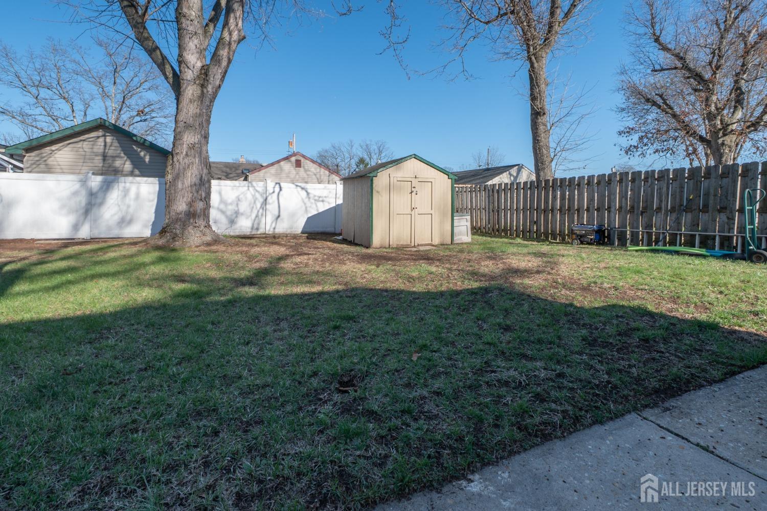 258 Sunset Avenue Old Bridge, NJ 08857 - Photo 25 of 27 a white house that has tree in front of it