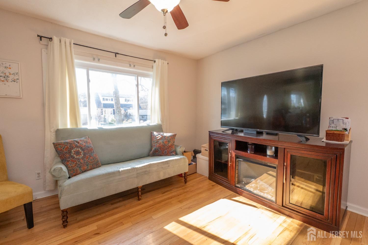 258 Sunset Avenue Old Bridge, NJ 08857 - Photo 5 of 27 a living room with furniture and a flat screen tv