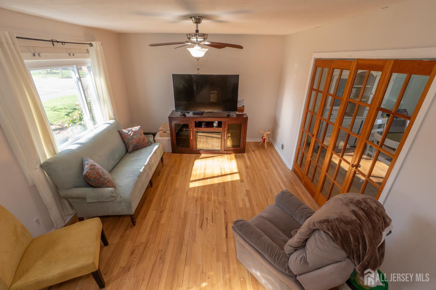 258 Sunset Avenue Old Bridge, NJ 08857 - Photo 6 of 27 a living room with furniture and a flat screen tv