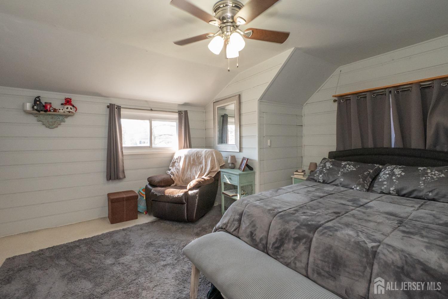 258 Sunset Avenue Old Bridge, NJ 08857 - Photo 9 of 27 a bedroom with a bed couch and window