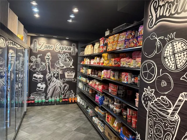 a room with stainless steel appliances and cabinets