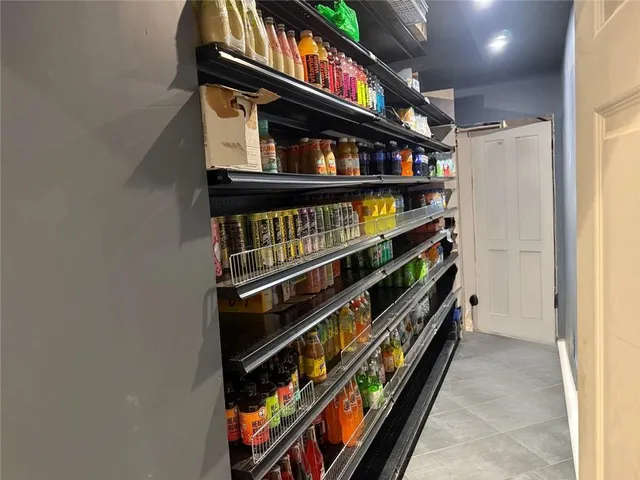a kitchen with lots of clutter and stainless steel appliances