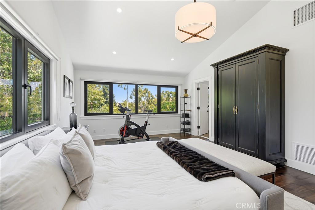 24884 Jim Bridger Road Hidden Hills, CA 91302 - Photo 20 of 31 a bedroom with a bed and a large window