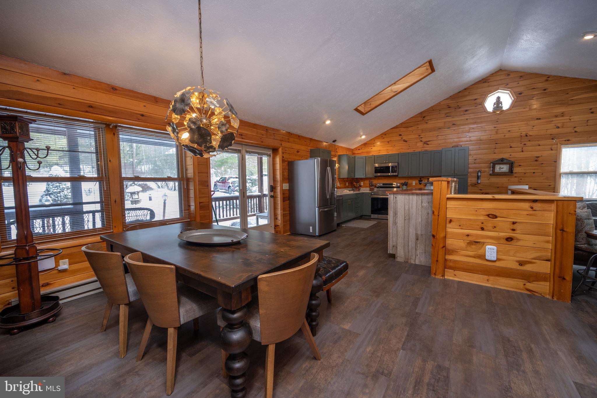 300 Normas Way McHenry, MD 21541 - Photo 15 of 48 a dining room with furniture a chandelier and wooden floor