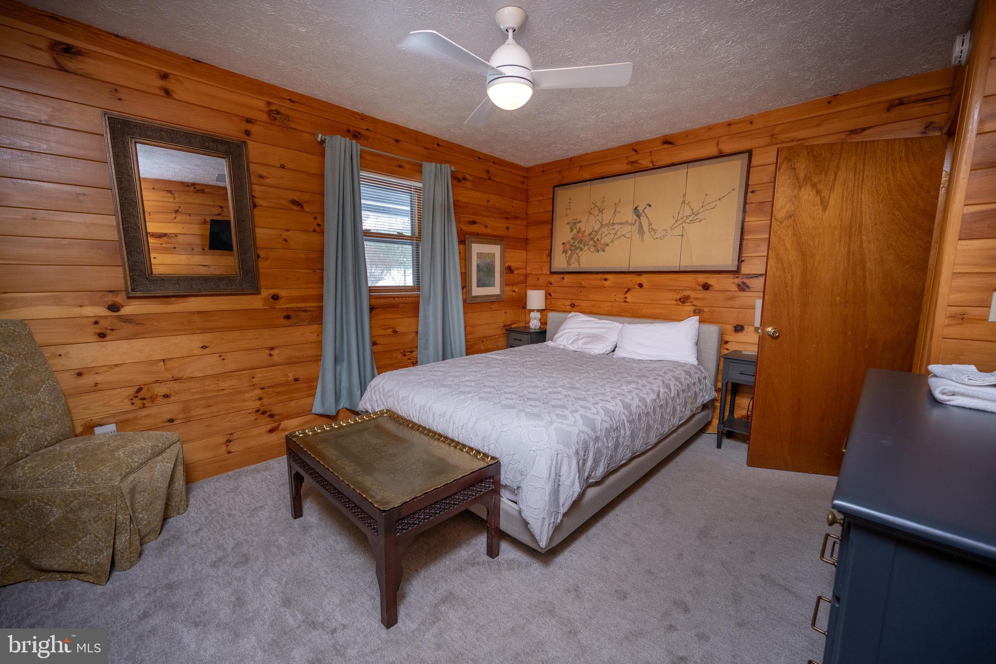 300 Normas Way McHenry, MD 21541 - Photo 16 of 48 a spacious bedroom with a bed and wooden floor