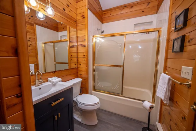 a bathroom with a toilet a sink and shower