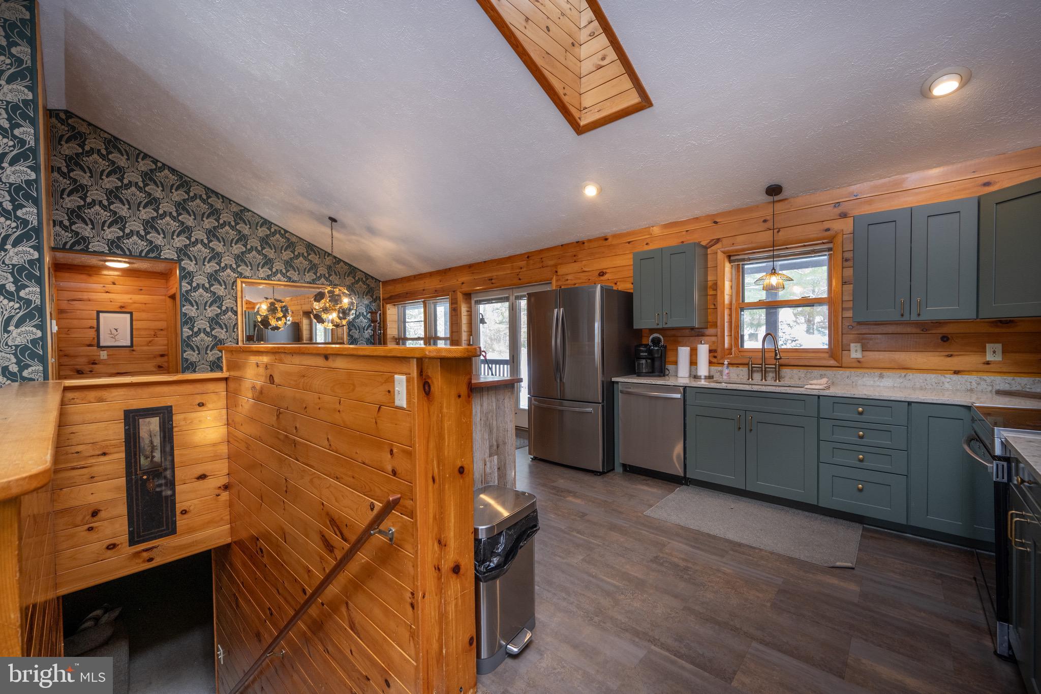 300 Normas Way McHenry, MD 21541 - Photo 23 of 48 a kitchen with granite countertop a refrigerator a sink a stove and wooden floors