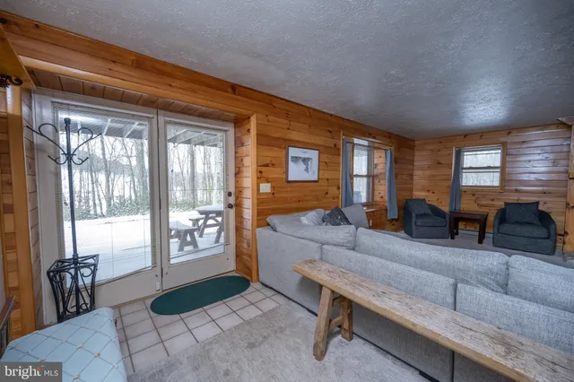 a spacious bedroom with a bed and wooden floor