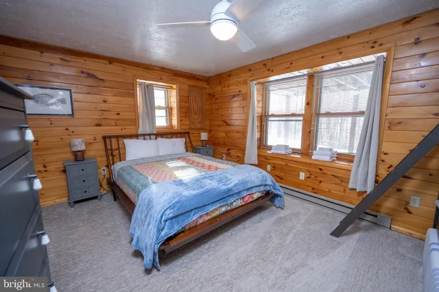 a bedroom with a bed and a television