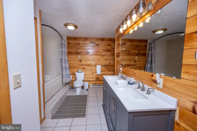 a bathroom with a toilet a sink and bathtub
