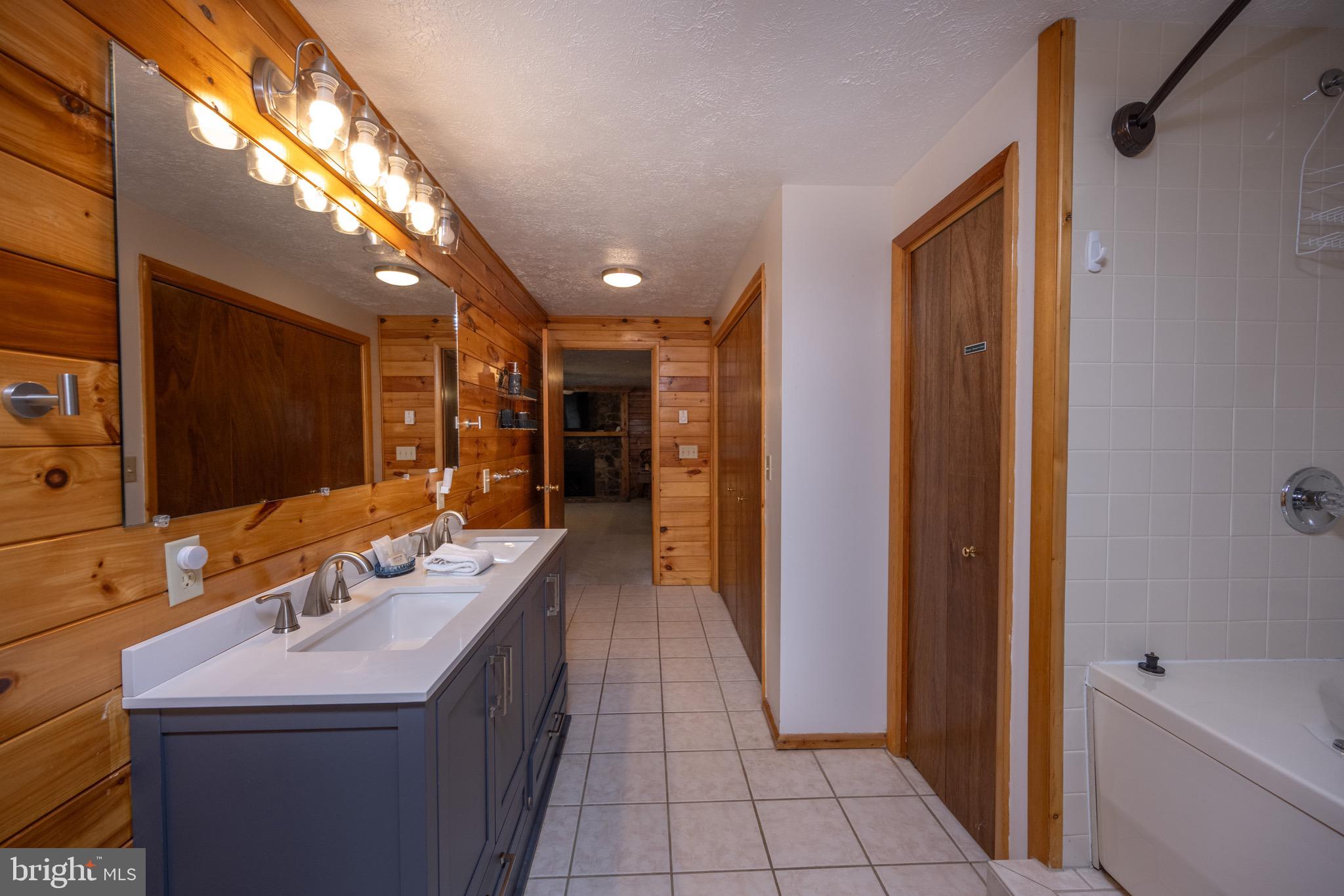 300 Normas Way McHenry, MD 21541 - Photo 36 of 48 a bathroom with a double vanity sink and a mirror