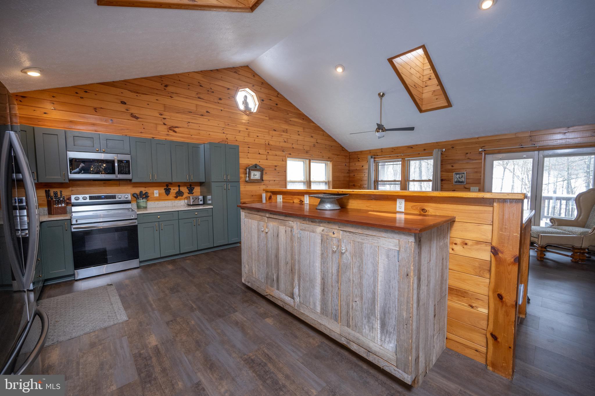 300 Normas Way McHenry, MD 21541 - Photo 4 of 48 a kitchen with stainless steel appliances kitchen island granite countertop a stove a sink and a refrigerator