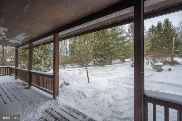 a view of a porch with furniture and floor to ceiling window