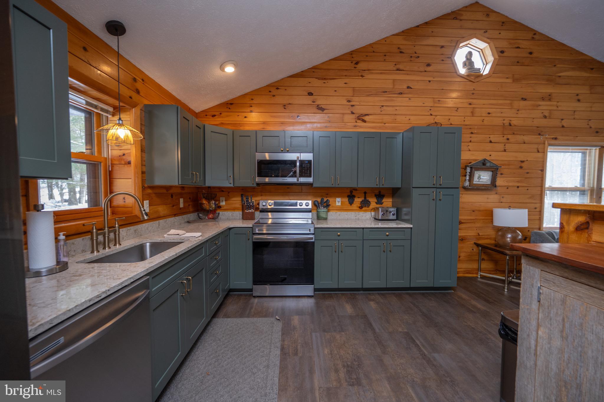 300 Normas Way McHenry, MD 21541 - Photo 6 of 48 a kitchen with stainless steel appliances wooden cabinets and a stove top oven