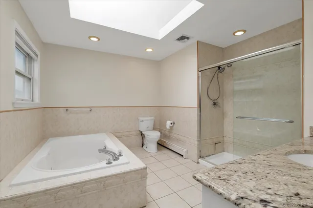 a bathroom with a tub a sink and a shower