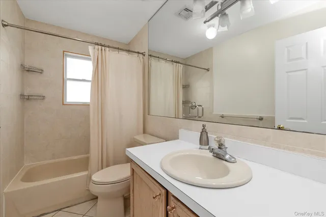 a bathroom with a sink toilet tub and shower