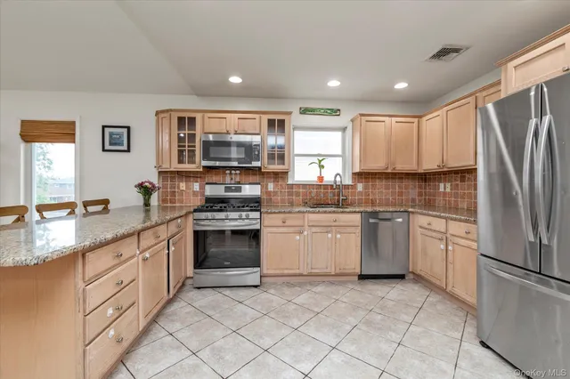 a kitchen with a sink stove and refrigerator