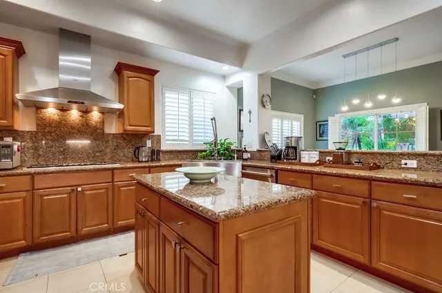 a sink and a stove top oven sitting inside of a kitchen