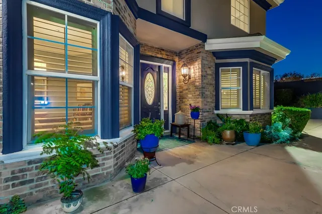 a front view of a house with potted plants