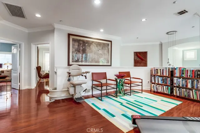 a living room with furniture kitchen view and large window
